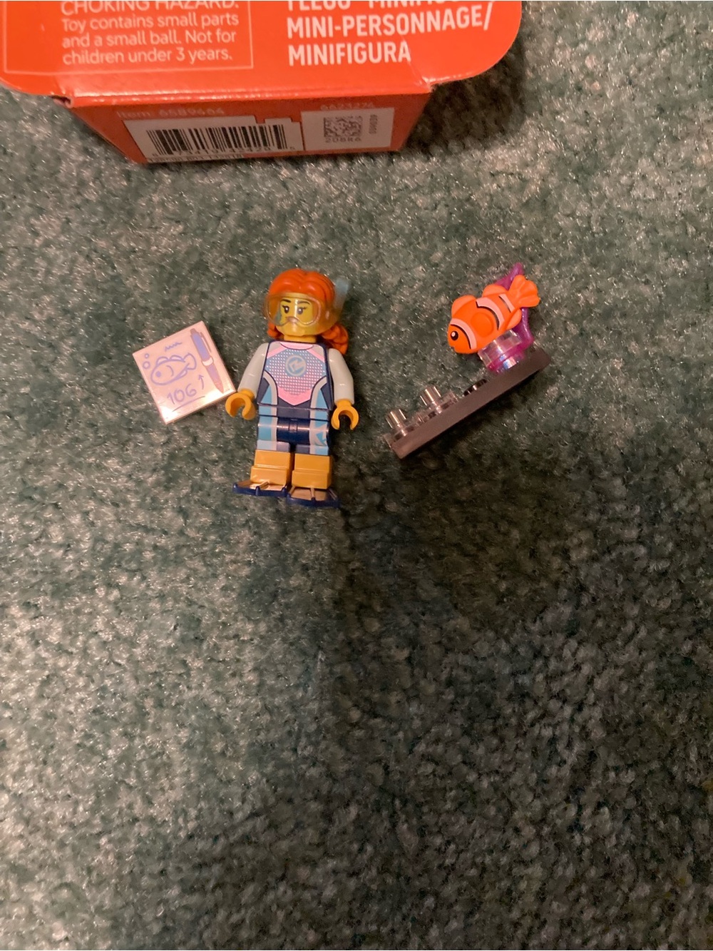 Lego orange-haired female minifigure with clownfish and printed tile